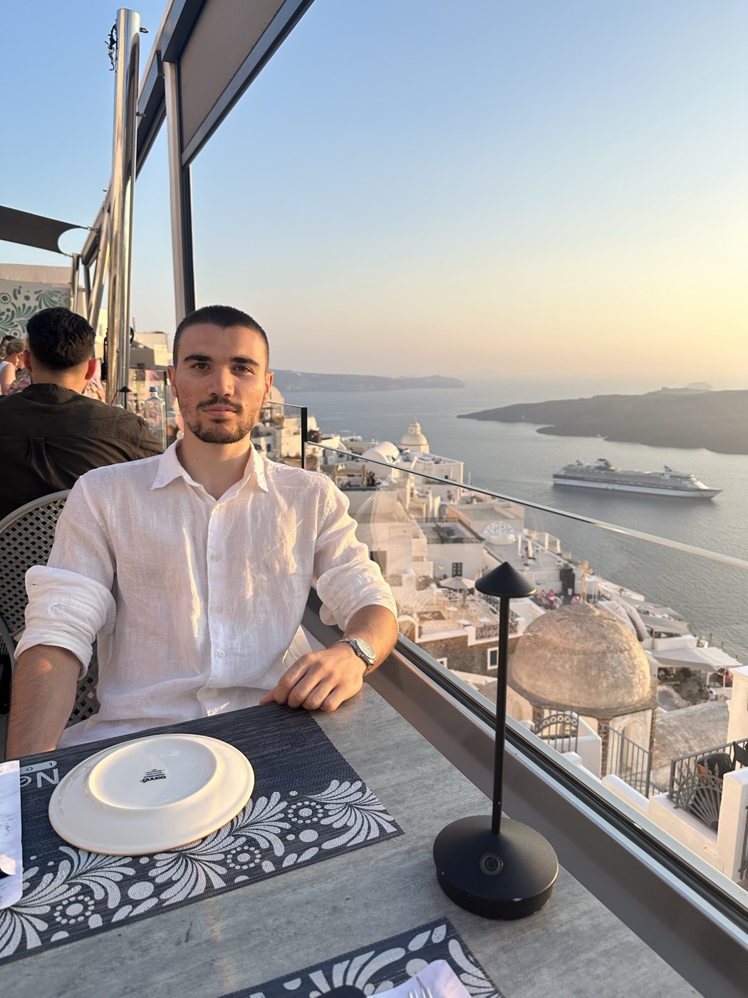 Deniz Sancar at a rooftop restaurant in Santorini